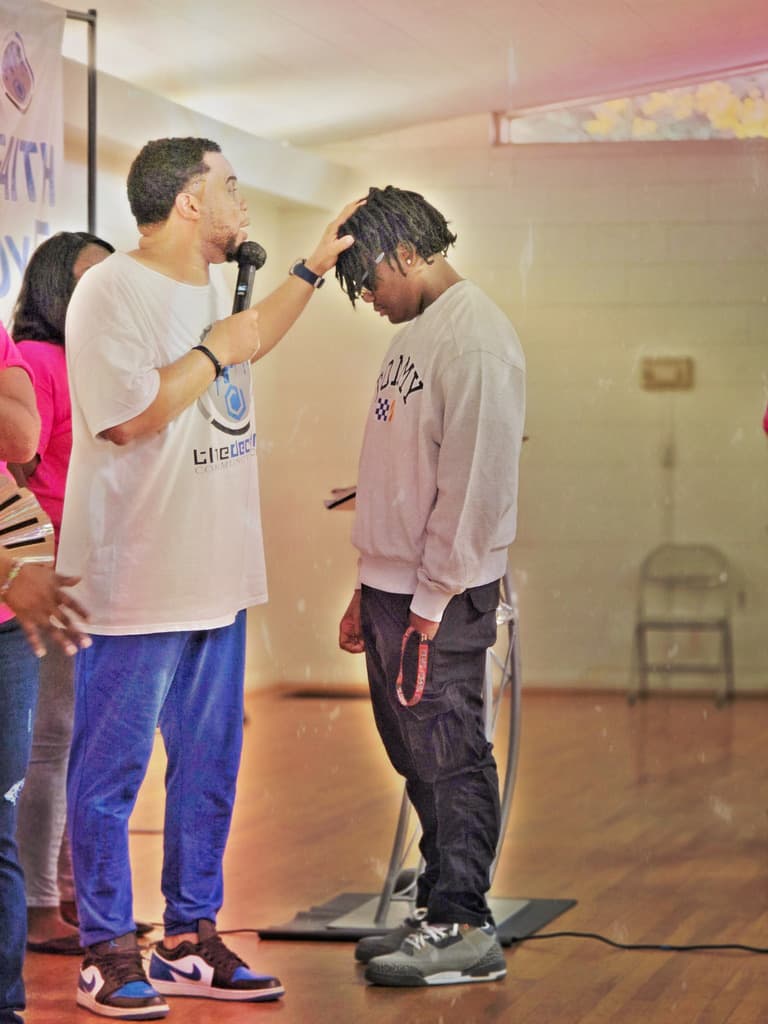 Prayer during a gathering at The Decision Christian Assembly